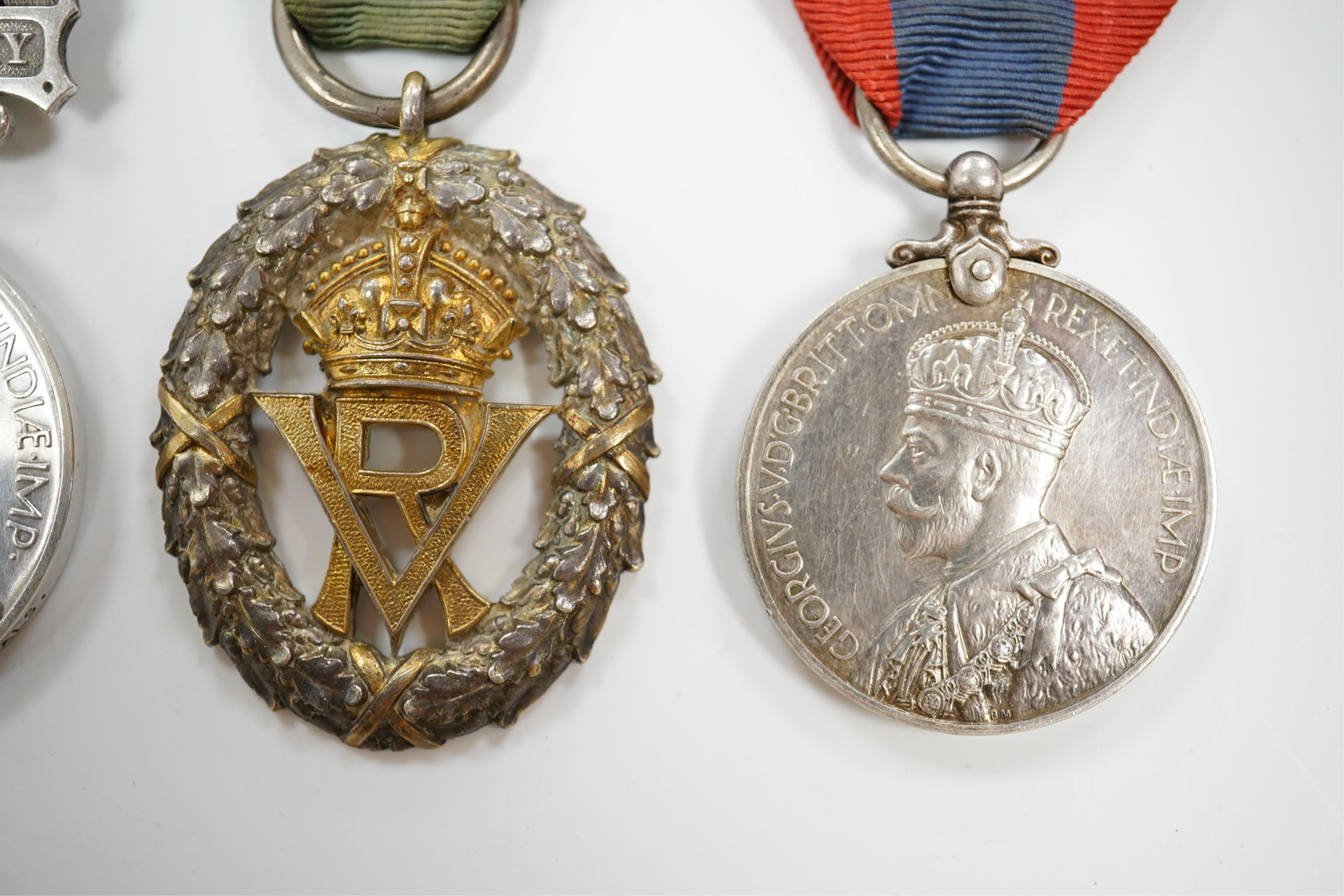 Four assorted service medals; Volunteer Officer's Decoration, hallmarked for 1892; EdVII Volunteer Long Service Medal to 3648 Pte W.Austin I/V B:Lanc:Fus; GV Imperial Service Medal to Frederick Allan Heselwood & Gv Regul